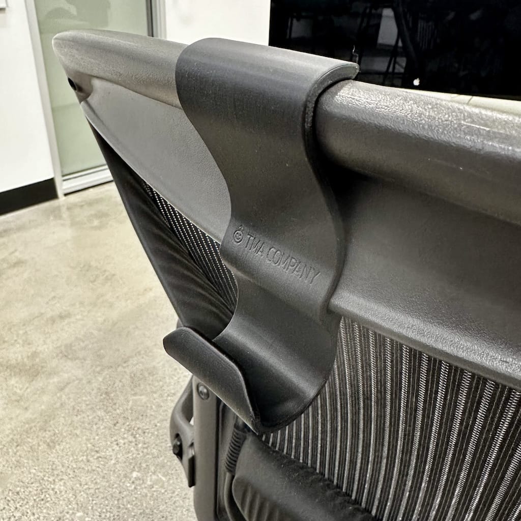 Close-up of backpack/bag hanger on Herman Miller Aeron office chair Close-up of backpack/bag hanger on Herman Miller Aeron office chair